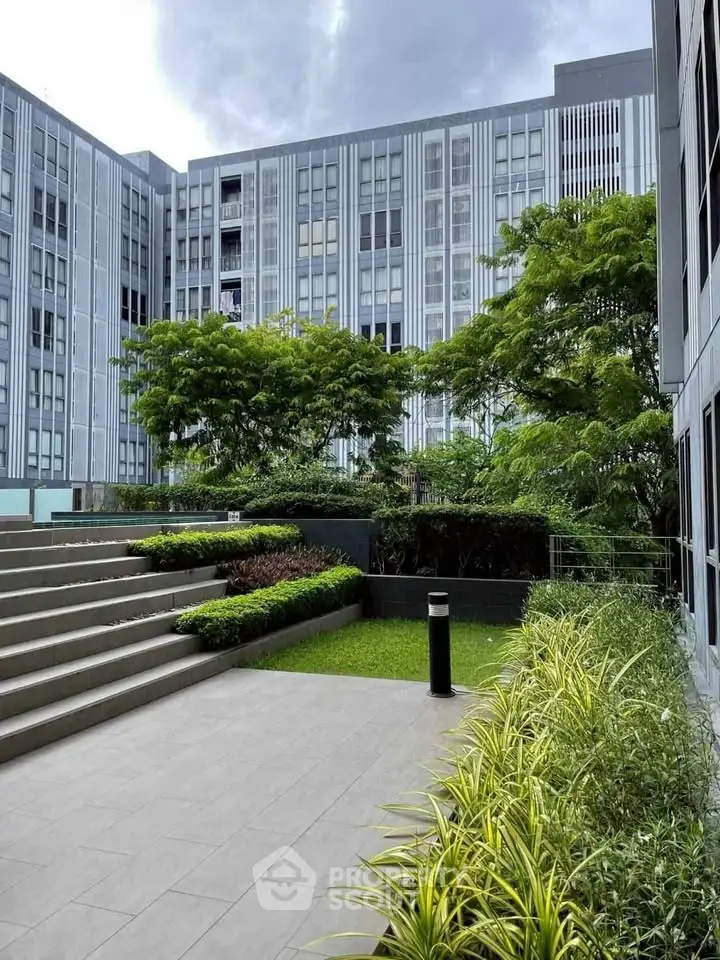 Modern building exterior with lush greenery and landscaped garden