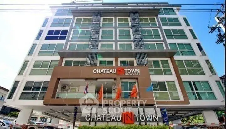 Modern urban condominium building with sleek design and multiple balconies.