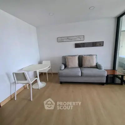 Cozy modern living room with stylish sofa and dining area, perfect for urban living.