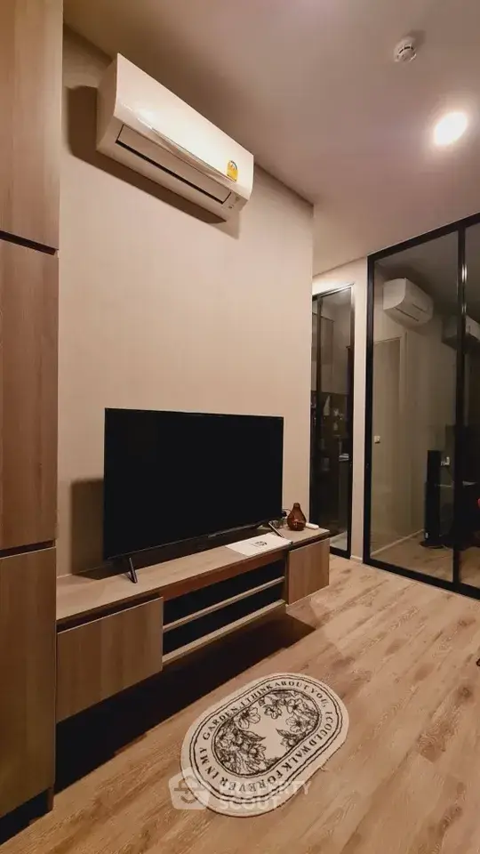 Modern living room with sleek wooden flooring and stylish TV setup