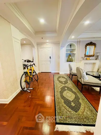 Elegant living room with hardwood floors and decorative archways