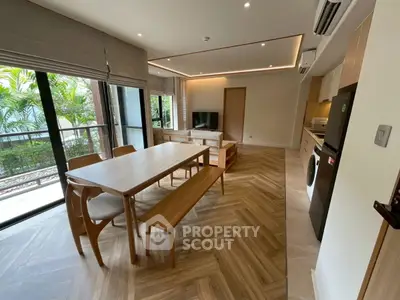 Spacious modern living room with dining area and garden view