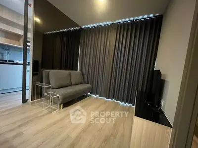 Modern living room with sleek sofa and floor-to-ceiling curtains