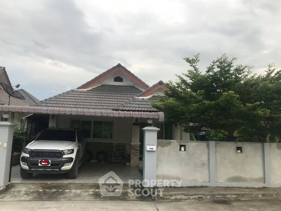 Charming suburban house with carport and lush greenery, perfect for family living.