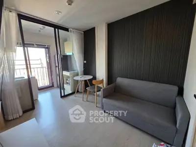 Modern living room with balcony access and sleek furniture in a stylish apartment.