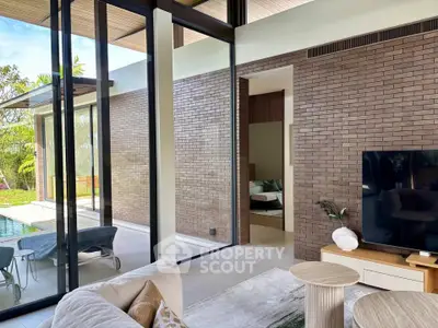 Luxurious modern living room with floor-to-ceiling windows and pool view