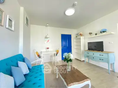 Charming living room with vibrant blue accents and cozy seating area