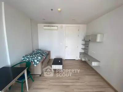 Modern living room with sleek furniture and wooden flooring in a cozy apartment.