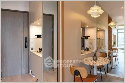 Modern apartment interior with stylish dining area and large mirror reflecting natural light.