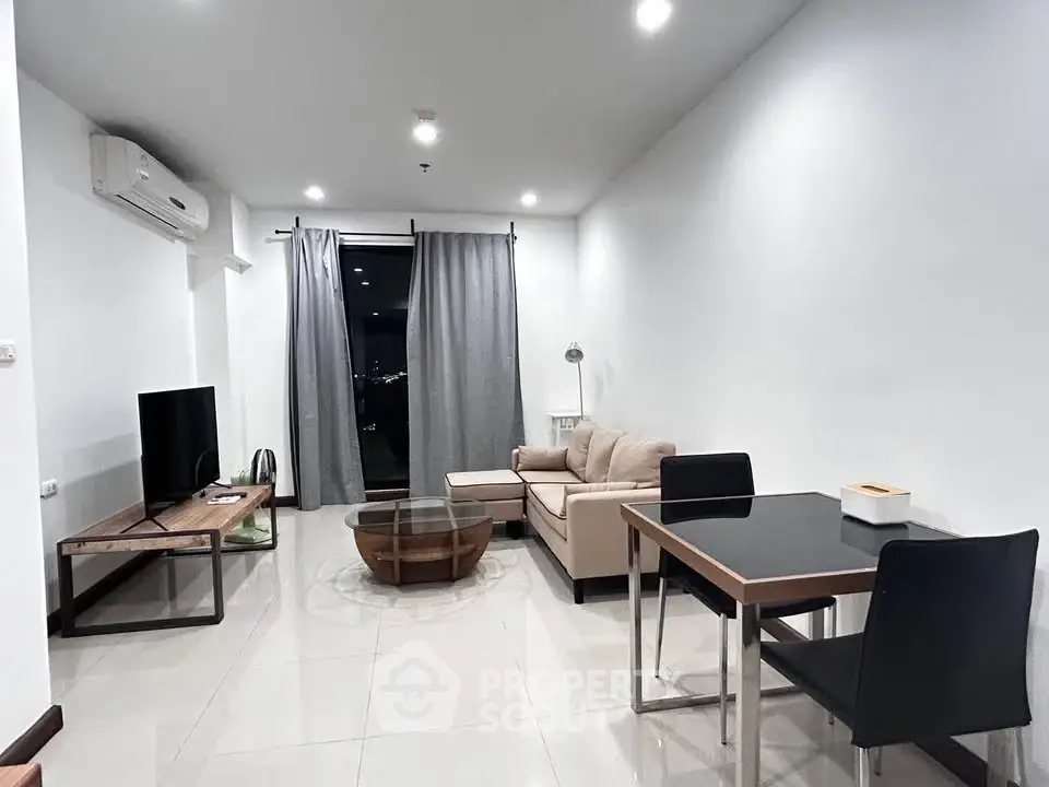 Modern living room with sleek furniture and city view, perfect for urban living.