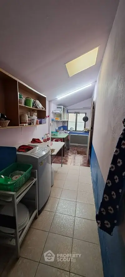 Cozy kitchen with washing machine and ample storage in a compact layout