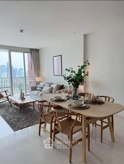 Spacious modern living room with dining area and city view, perfect for urban living.