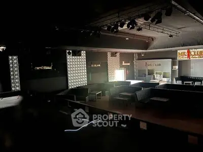 Spacious nightclub interior with modern seating and ambient lighting.