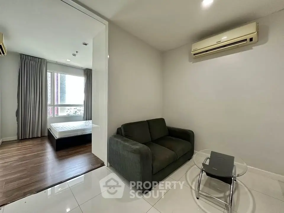 Modern apartment interior with cozy living area and bedroom view