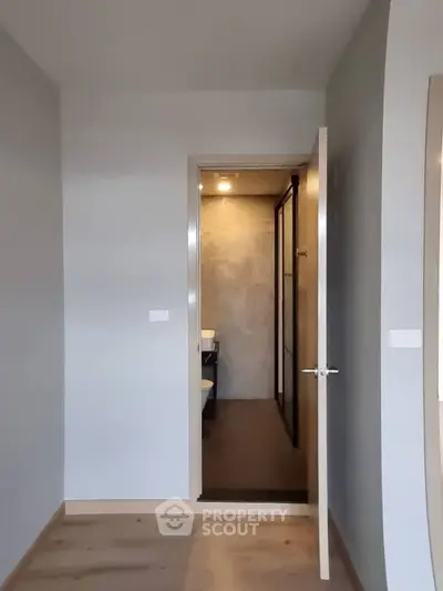 Modern interior with open door leading to a sleek bathroom