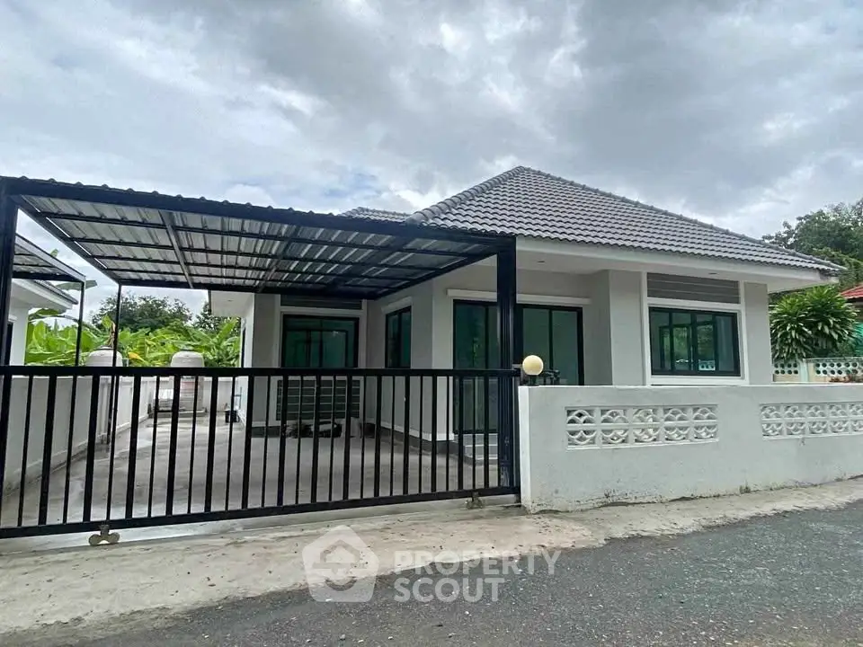 Charming single-story house with modern design and spacious driveway, perfect for family living.