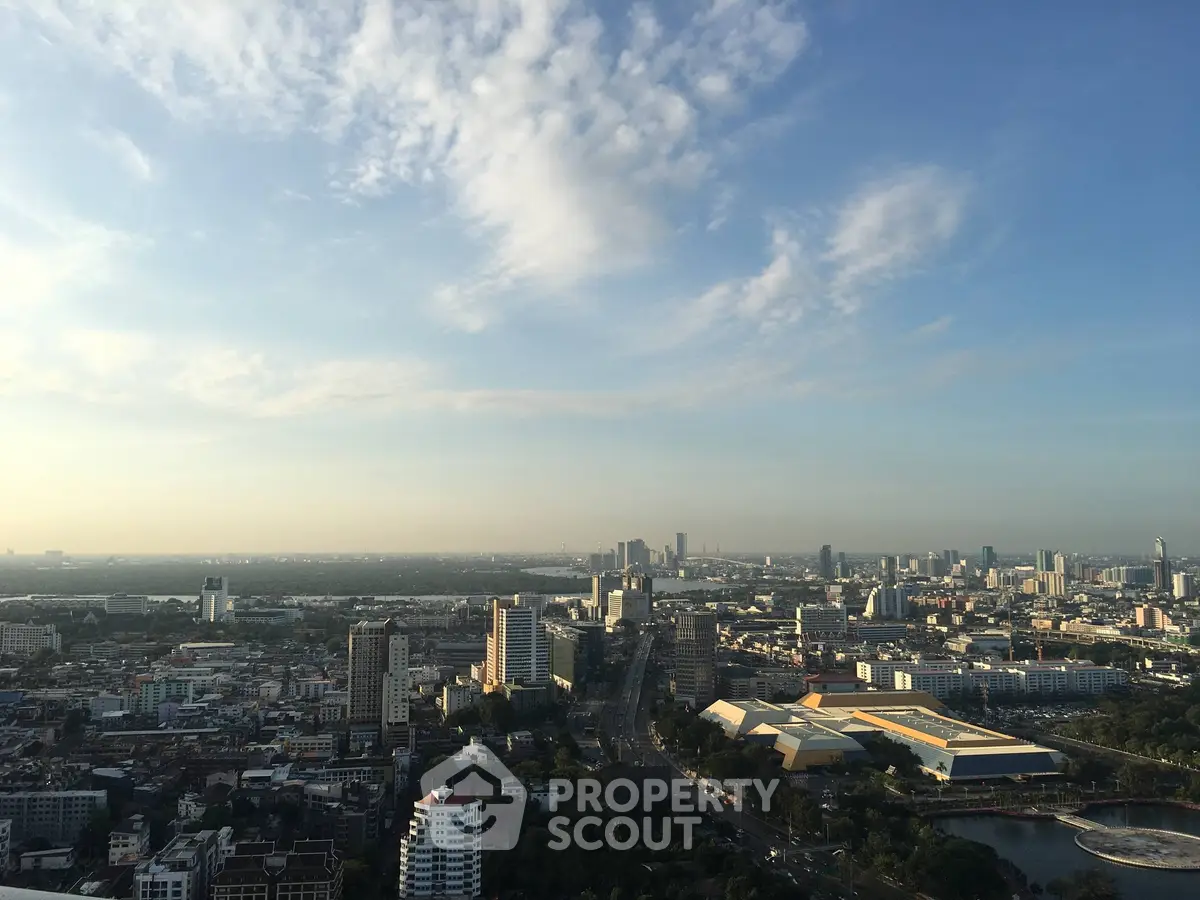 Stunning cityscape view from a high-rise building showcasing urban skyline and expansive sky.