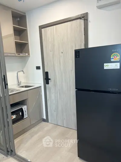 Modern kitchen with sleek black cabinets and integrated appliances