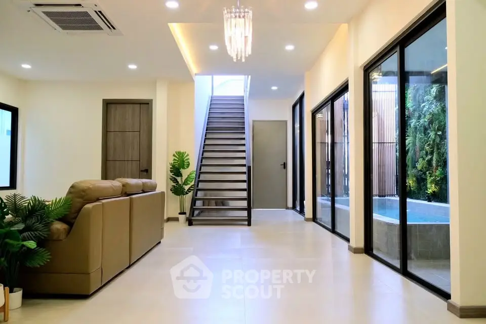 Spacious modern living room with elegant staircase and natural light