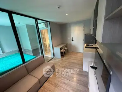 Modern studio apartment with open layout, featuring a cozy living area and compact kitchen.