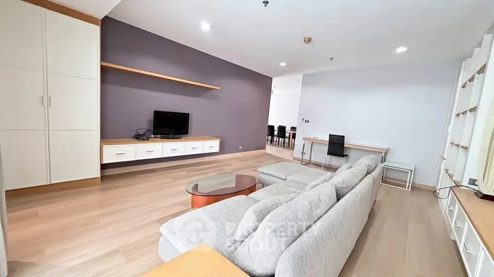 Spacious modern living room with sleek furniture and open layout, perfect for entertaining.