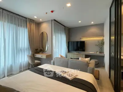 Luxurious modern bedroom with elegant decor and cozy seating area, perfect for relaxation and comfort.