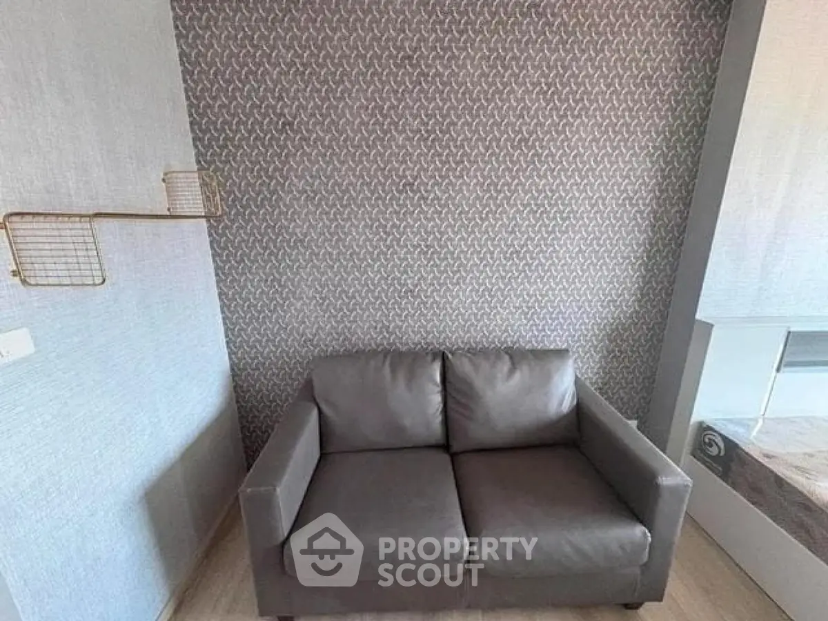 Modern living room with stylish wallpaper and cozy gray sofa