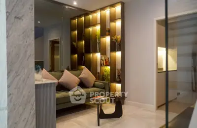Stylish living room with modern shelving and cozy seating in a contemporary apartment.