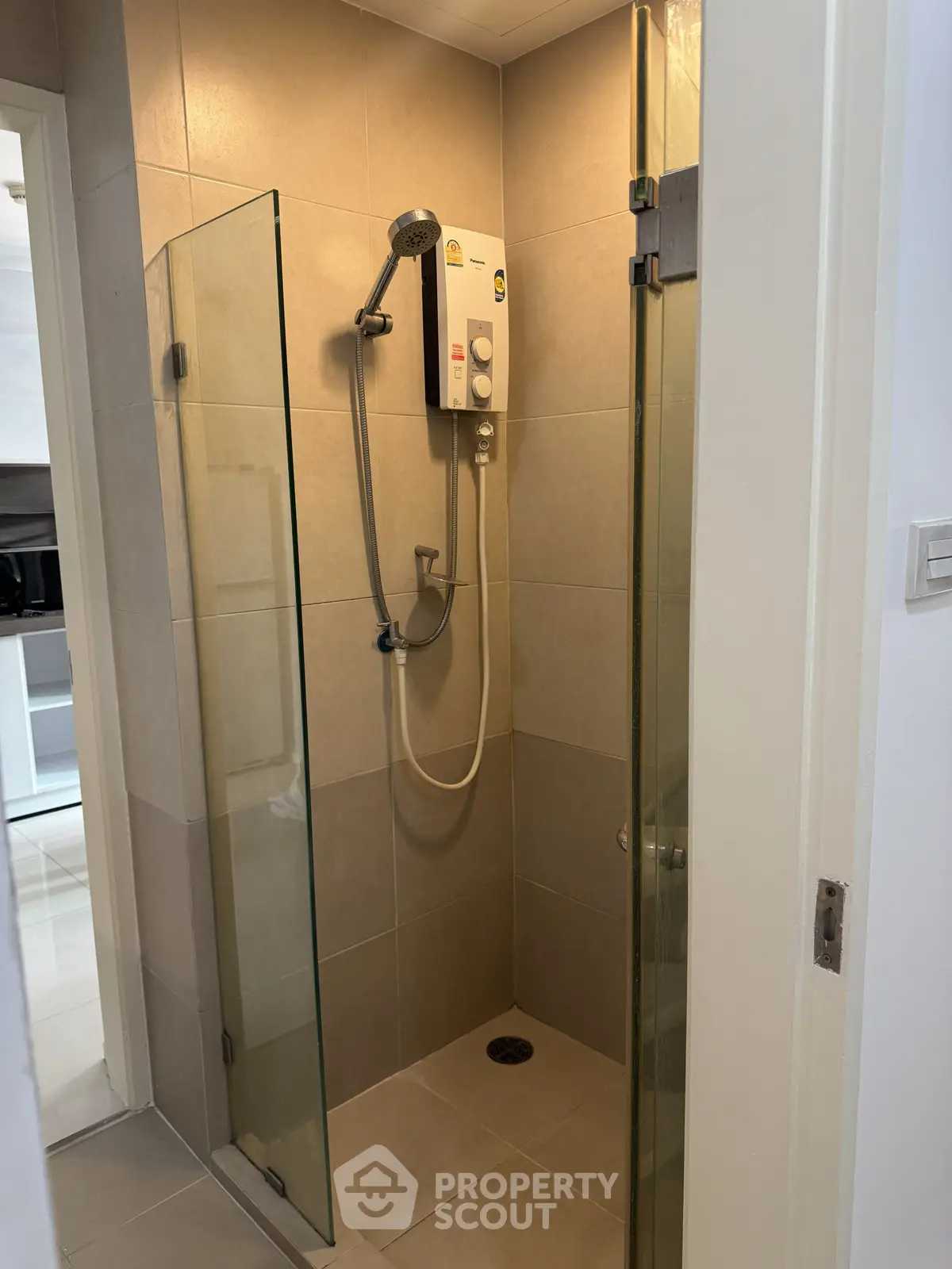 Modern bathroom with glass shower enclosure and electric water heater