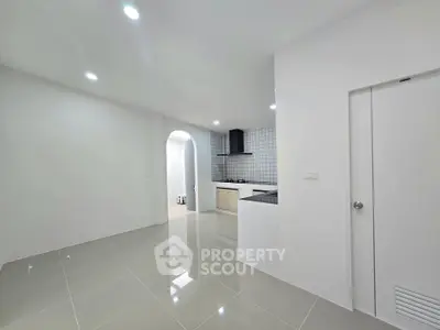 Modern minimalist kitchen with sleek tile flooring and open layout design.