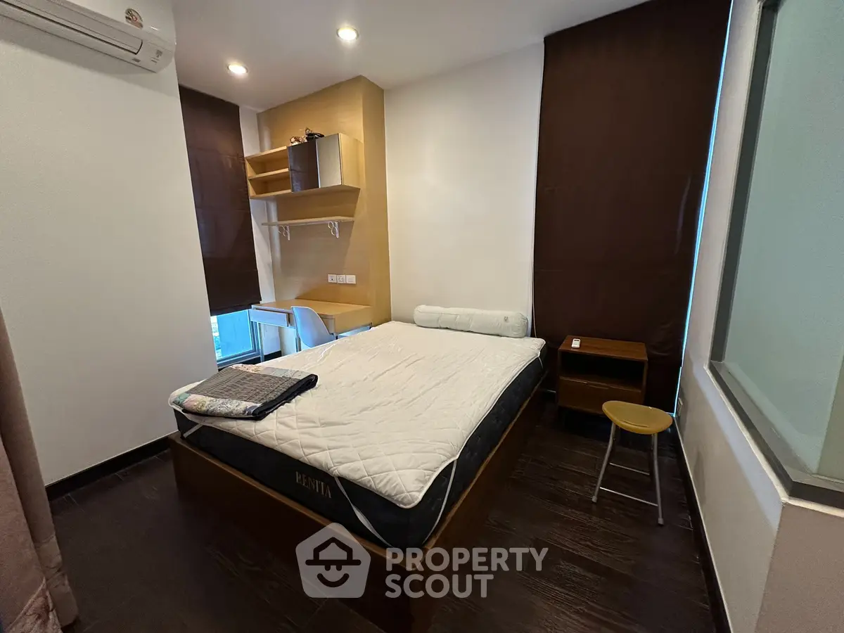 Modern bedroom with stylish furniture and natural lighting, perfect for a cozy living experience.