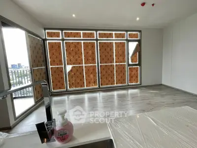 Spacious unfurnished living room with large windows and city view