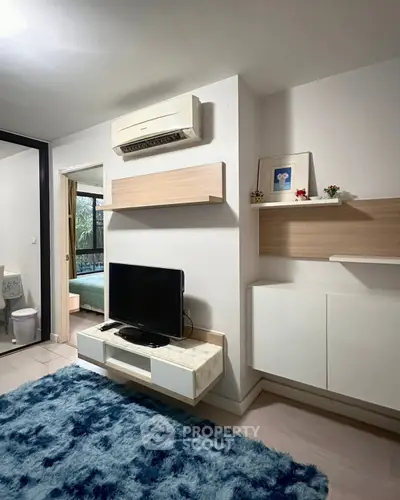 Modern living room with air conditioning and stylish decor in a cozy apartment.