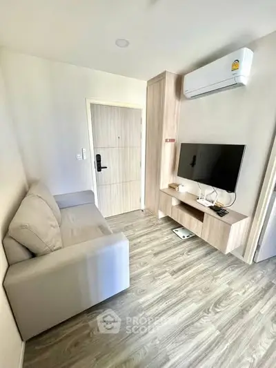 Modern living room with sleek furniture and wall-mounted TV, perfect for cozy relaxation.