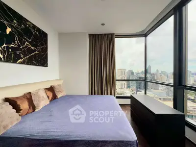 Luxurious bedroom with stunning city view and modern decor in high-rise apartment.