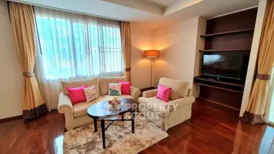 Charming living room with cozy seating and natural light, perfect for relaxation.