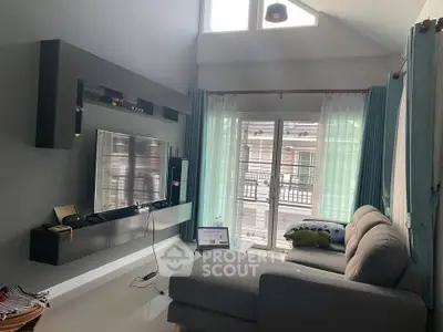 Modern living room with high ceiling and large windows for natural light