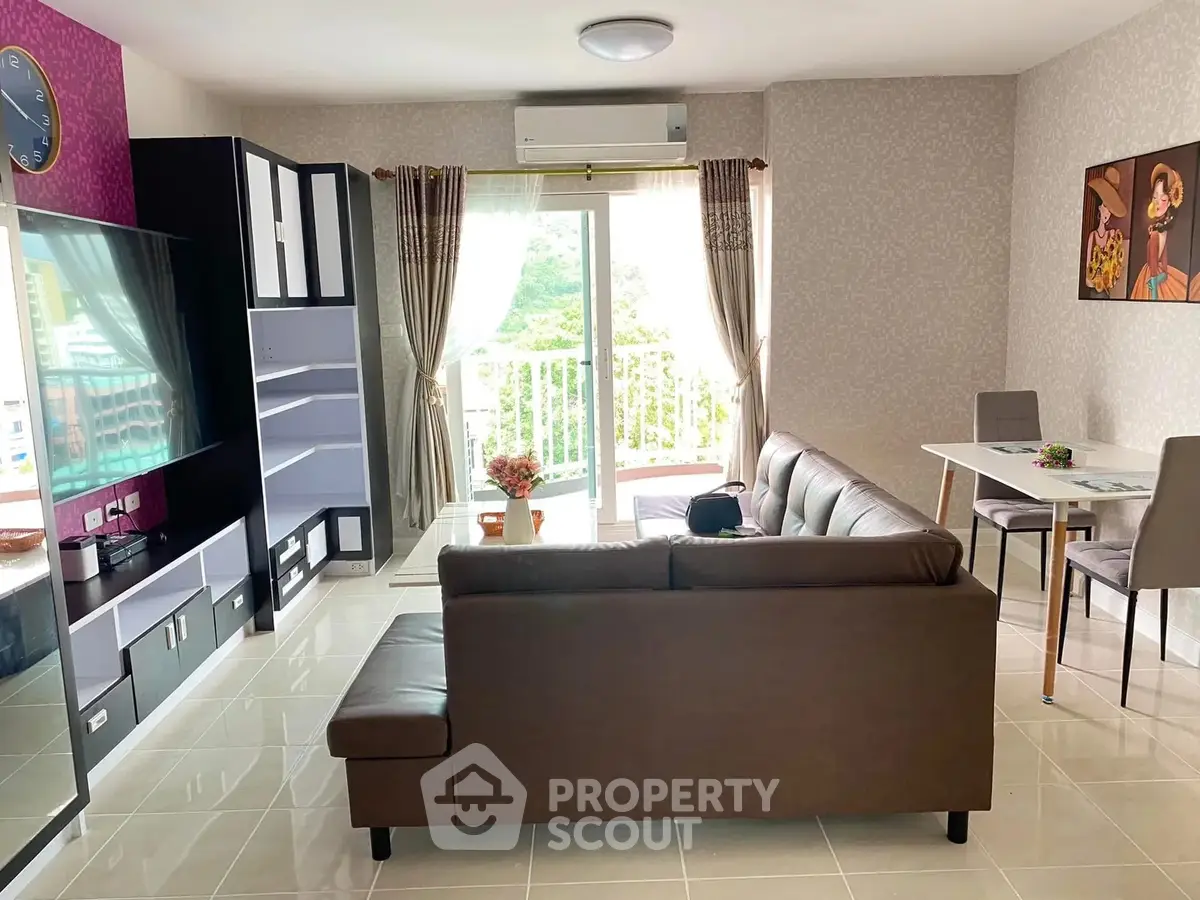 Modern living room with balcony view, stylish furniture, and natural light.