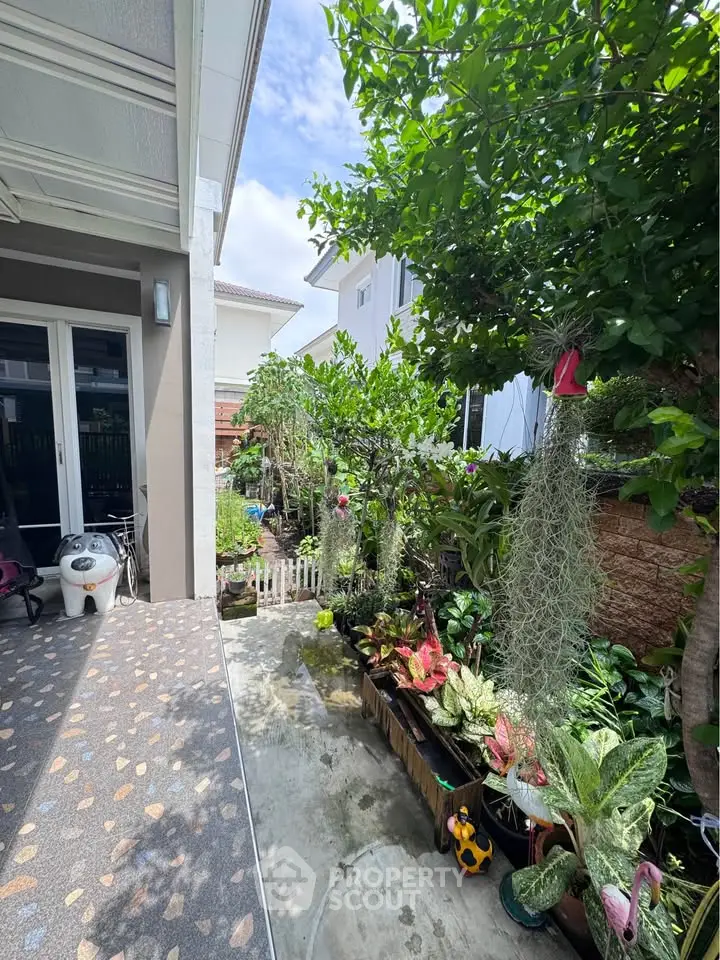 Charming garden view with lush greenery and cozy outdoor space in a residential property.