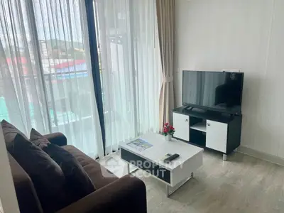 Modern living room with sleek furniture and large window view