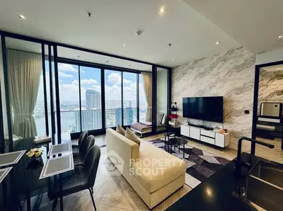 Luxurious living room with stunning city view, modern decor, and spacious layout in high-rise apartment.