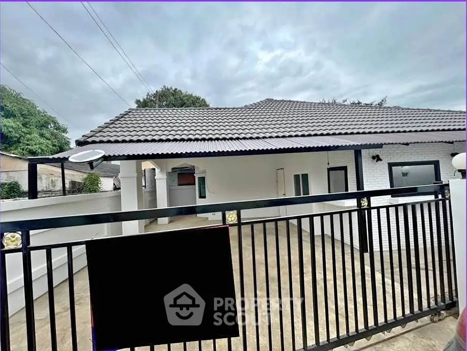 Charming single-story home with gated entrance and spacious driveway.