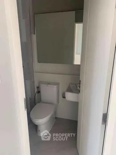 Modern compact bathroom with sleek design and neutral tones.