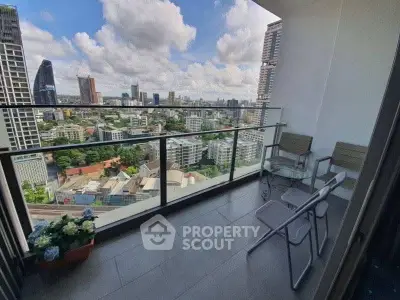Stunning high-rise balcony with panoramic city views and modern seating area.