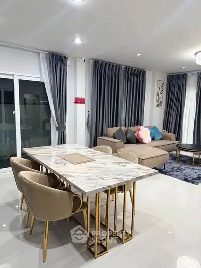 Luxurious living room with elegant marble dining table and plush seating