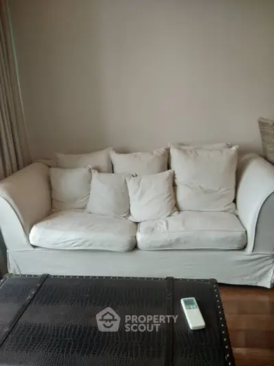 Cozy living room with plush beige sofa and stylish coffee table