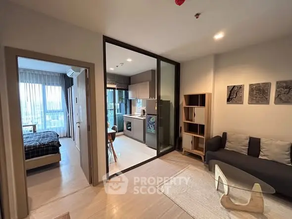 Modern apartment with open layout, featuring a cozy living room and sleek kitchen design.