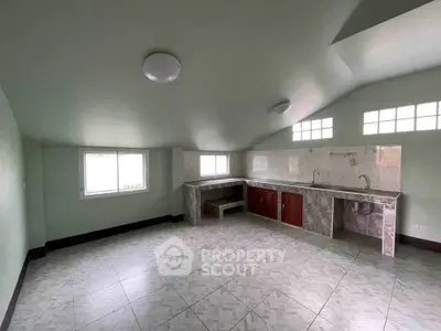 Spacious kitchen with tiled floors and ample natural light