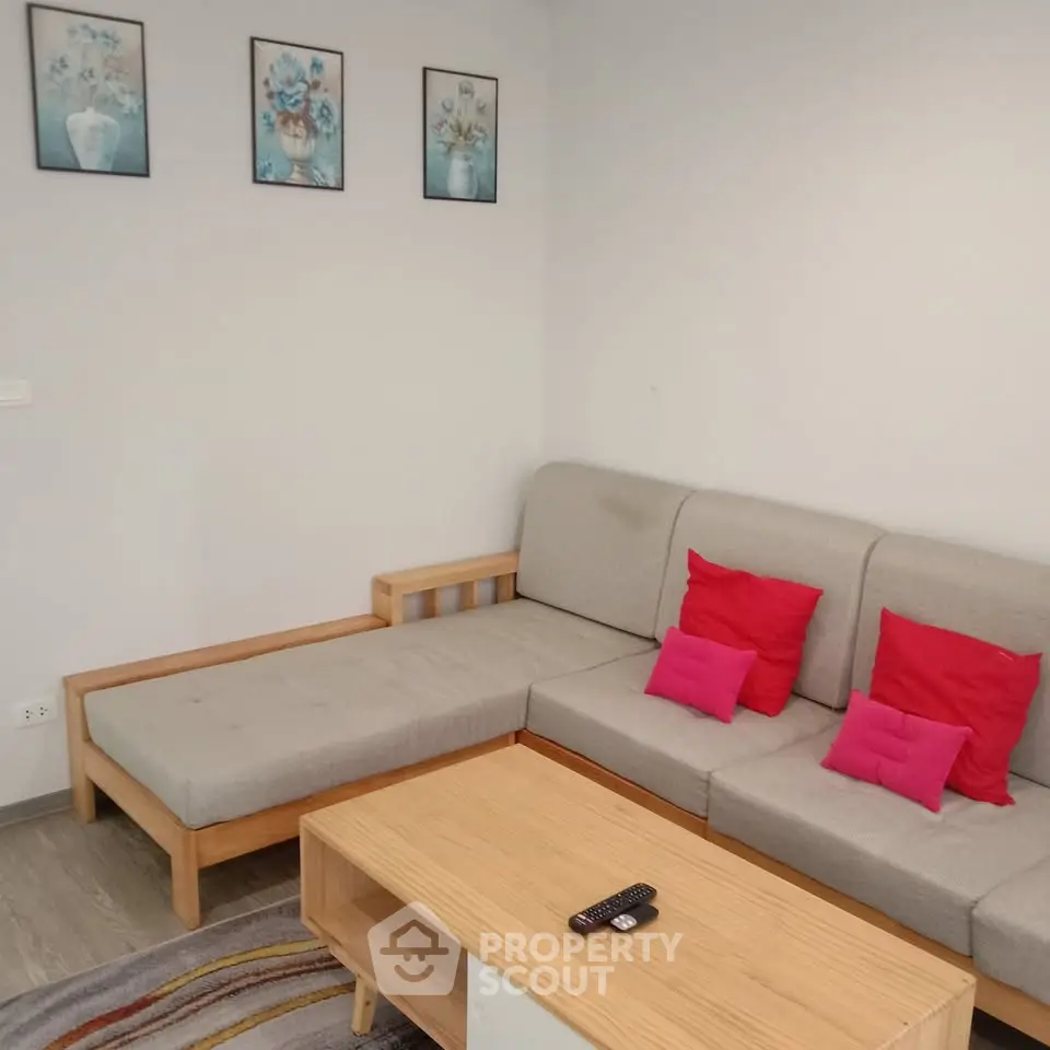 Cozy living room with modern sectional sofa and vibrant decor accents.
