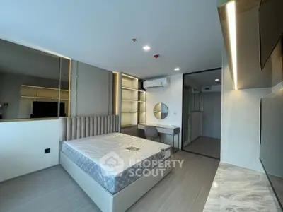 Modern bedroom with stylish decor and built-in storage in a luxury apartment.